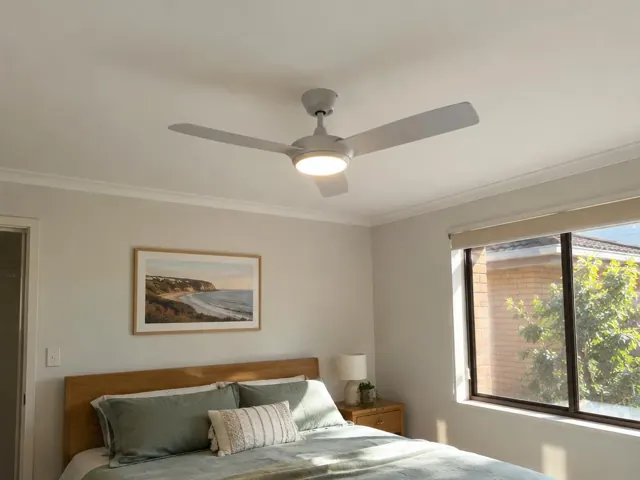 Bedroom with a ceiling fan, bed, window and bedside table in Belmont